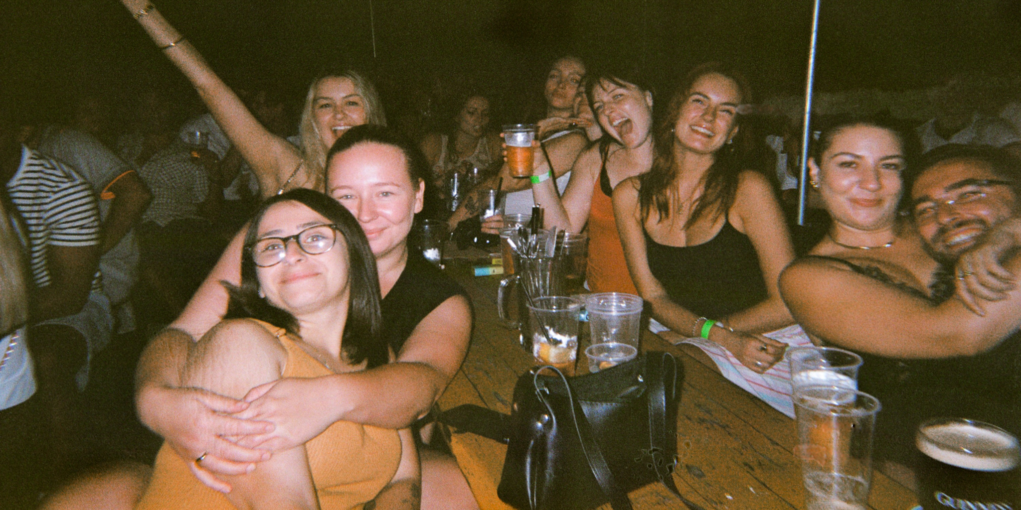 Photo of a group of female friends all posing and smiling for the camera